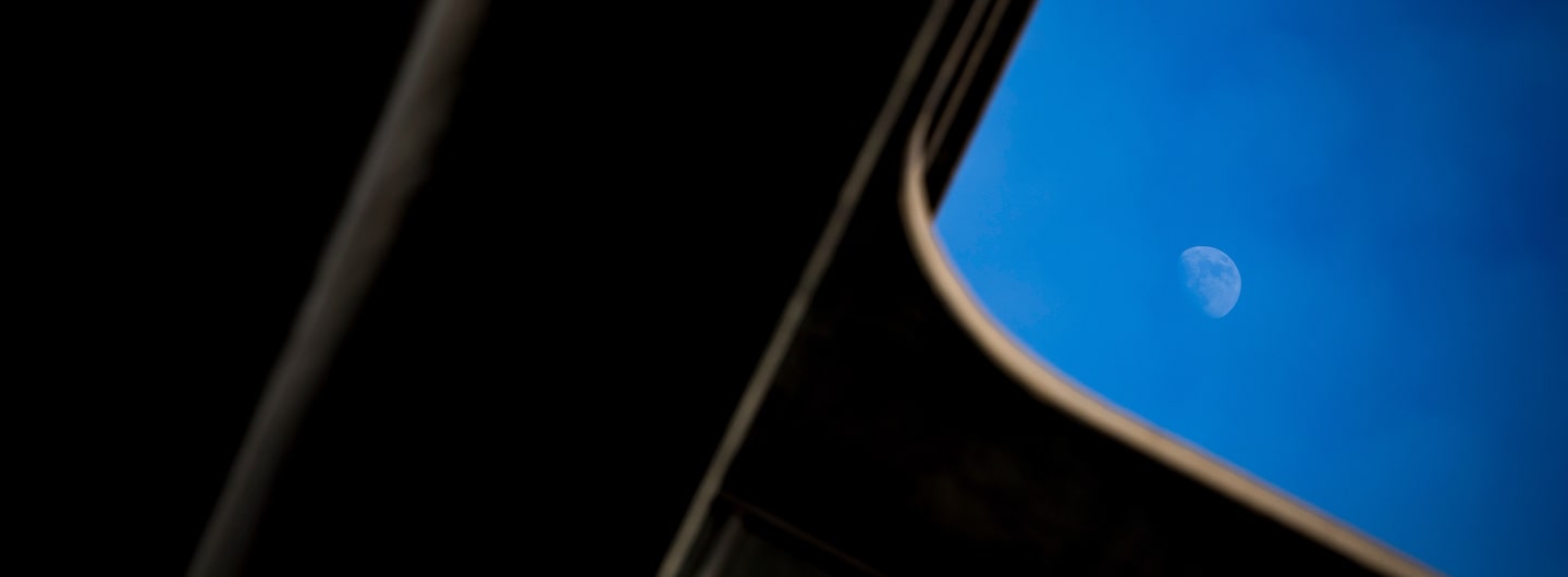 view of the moon through Geisel library