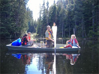 Photo of investigators in boat straining water through net