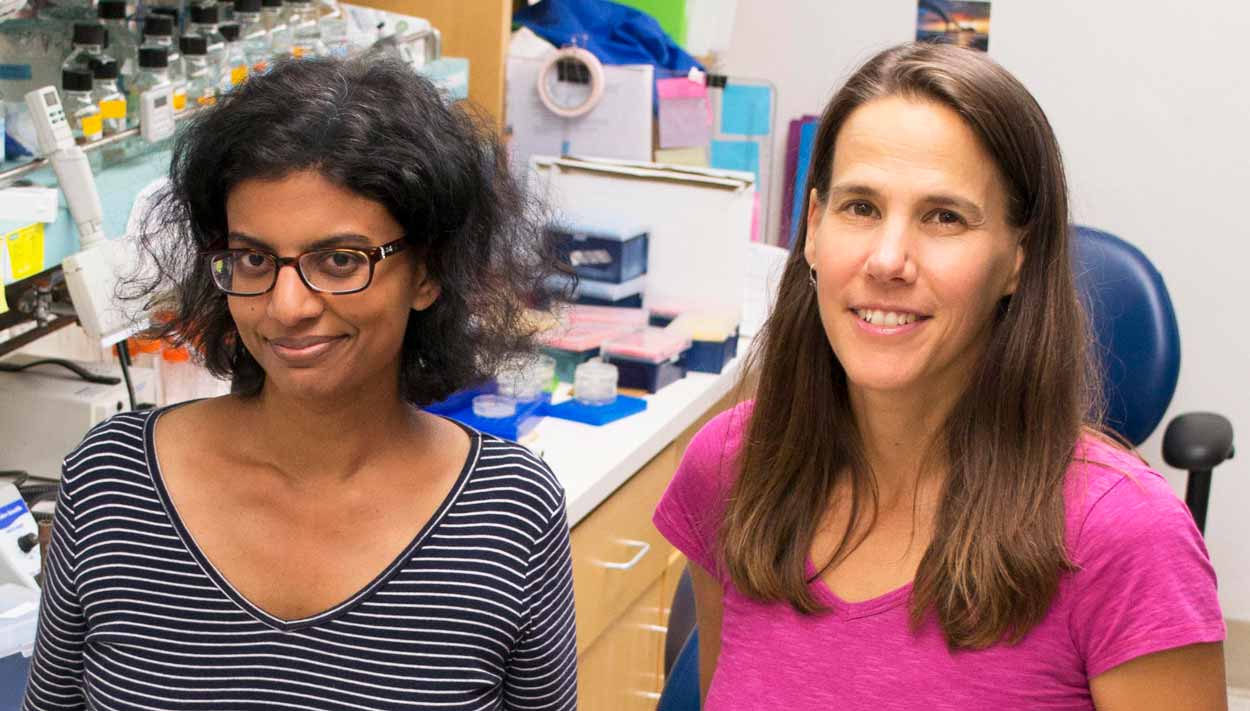 two female scientists (Reddy and Troemel) pose for a photo in the lab