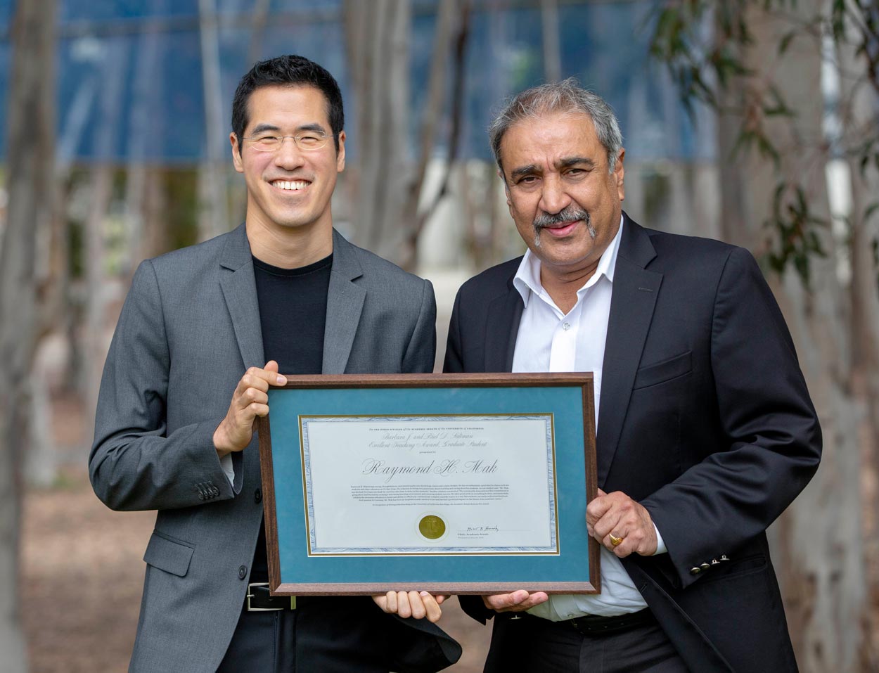 raymond mak and khosla holding an award