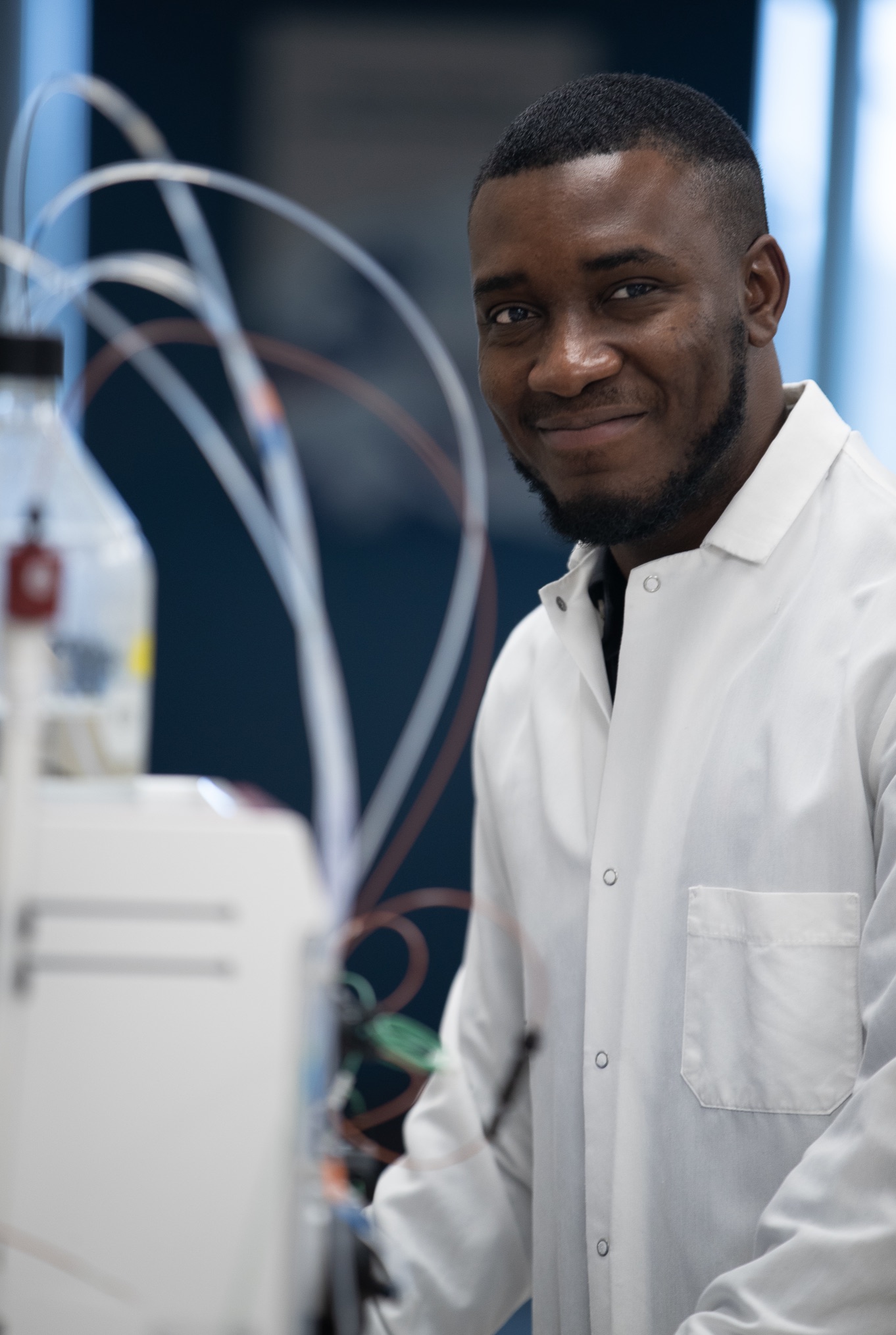 Scientist measuring liquid in pipette 