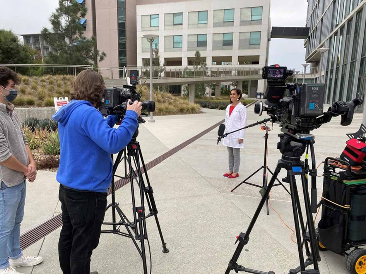 Behind the Scenes of a photo of a researcher in front of Tata Hall