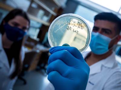 proefssor fabian rivera chavez holding up a petri dish